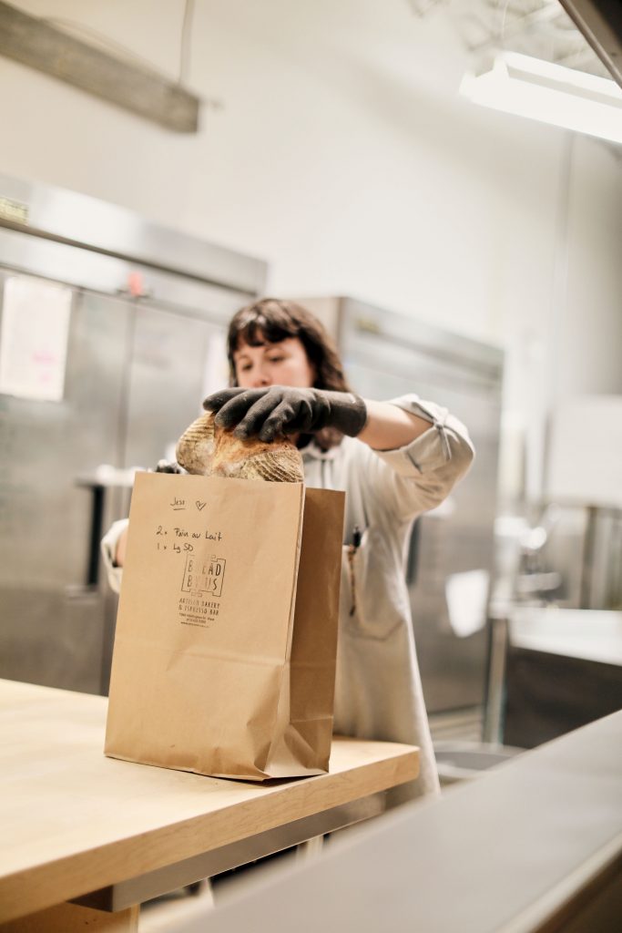 Woman packaging bread for delivery  